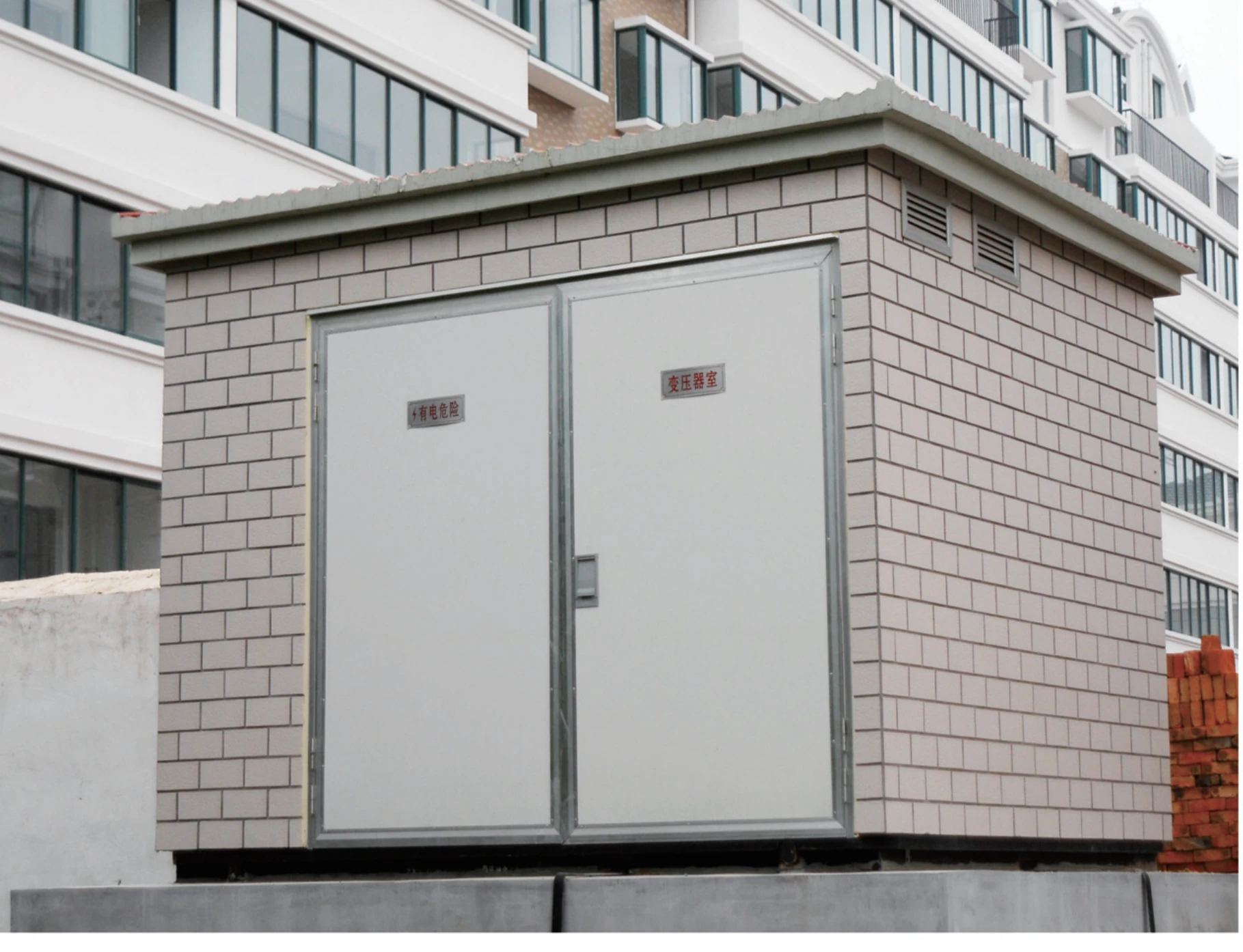 Prefabricated substation installed beside a building